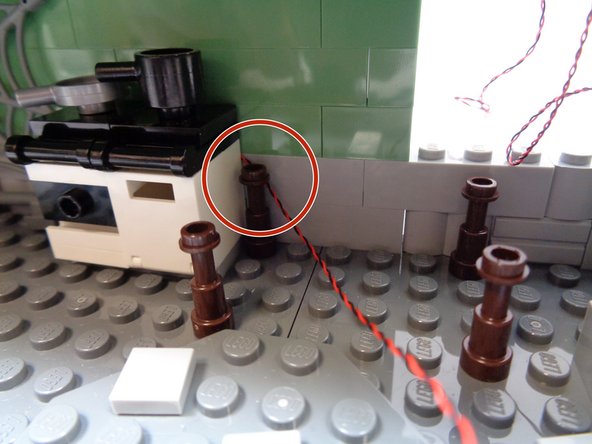 Place the stove assembly back in place.  As shown by the red circle in the first photo, make sure the oven light wire comes out the side of the oven.