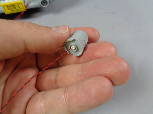 As shown in the third photo, carefully press the internal assembly back into place inside the barrel.