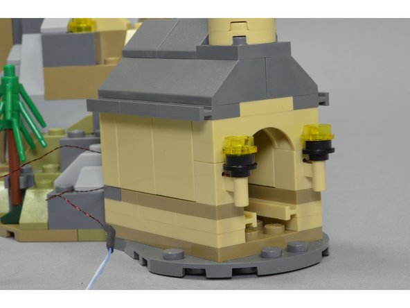 At the end of this step, you should have a re-assembled boathouse as shown in the third photo.