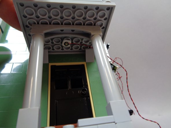 As shown in the second photo, mount the yellow light in the center of the side porch above the kitchen door.