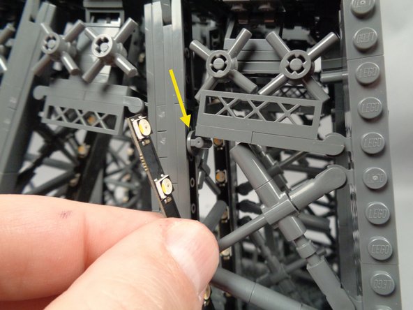 As shown by the yellow arrow in the second photo, be careful of the small walkway support piece when passing the light strip into the center of the pillar.