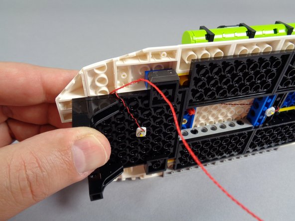 As shown in the second photo, carefully re-attach the plate bracket that supports the roof edge.  This will make the roof stable again.  Press up on this support at the same time you press down on the white roof slopes to secure everything in place.