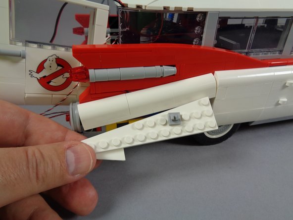 As shown in the photos for this step, re-assemble the right lower body parts you removed earlier, including the light bluish gray hose.