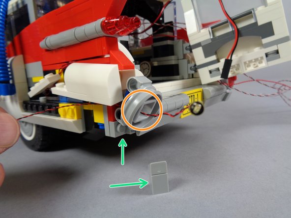 As shown in the first photo for this step, you will repeat the same steps you used for the right lower tail light to disassemble the left lower tail light and mount the last red Pico LED light.
