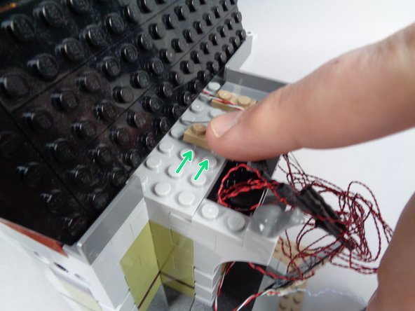 As shown in the first photo for this step, use your brick separator to remove the left 1x2 dark tan plate and move it two studs to the right.