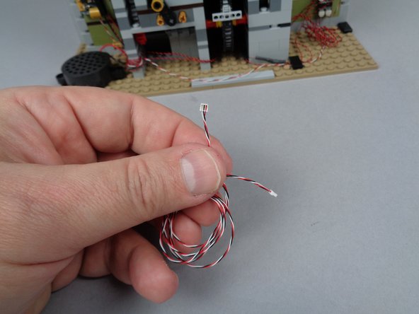 As shown in the first photo for this step, you will have one 3-wire connecting cable left in your BOX #3.