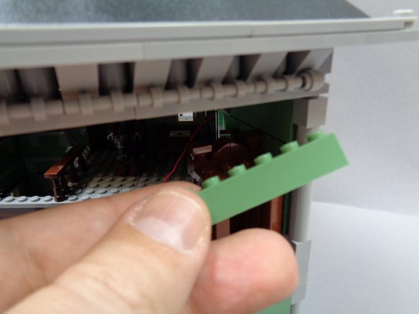 As shown in the photos for this step, you will now run the red control wire out the back of the bedroom wall.