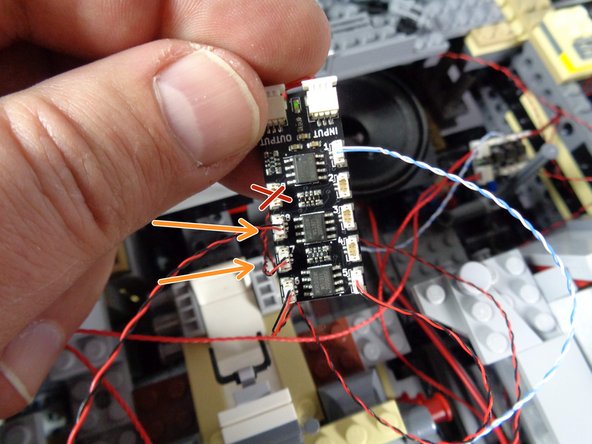 As shown by the two orange arrows in the third photo, connect these two wires to plugs #7 and #8 on the third BRANCH09X adapter board.