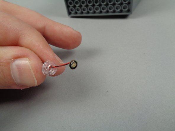 As shown in the first photo for this step, open the small pink bag with the yellow dot.