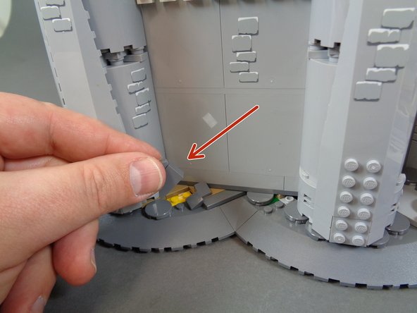 As shown in the third photo, remove the rockwork pieces that are holding the front castle wall in place.