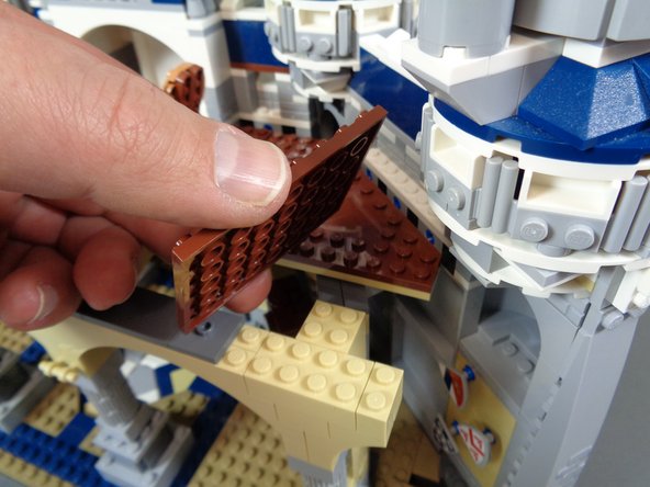 As shown in the first photo for this step, remove the large brown rectangle piece from the castle interior upper floor.