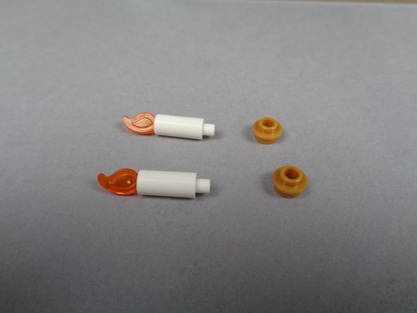 As shown in the photos for this step, remove the two candles from the obelisk room, and separate the candles from their gold plate bases.