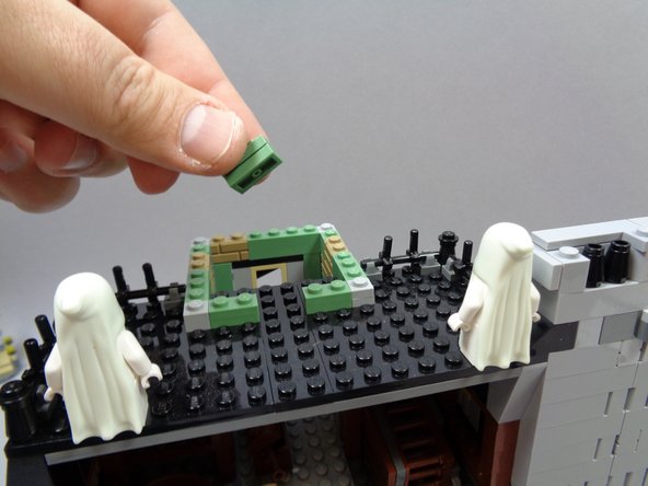 As shown in the photos for this step, remove the center rear section of the cupola wall (two sand green 1x2 plates as shown in the first photo).