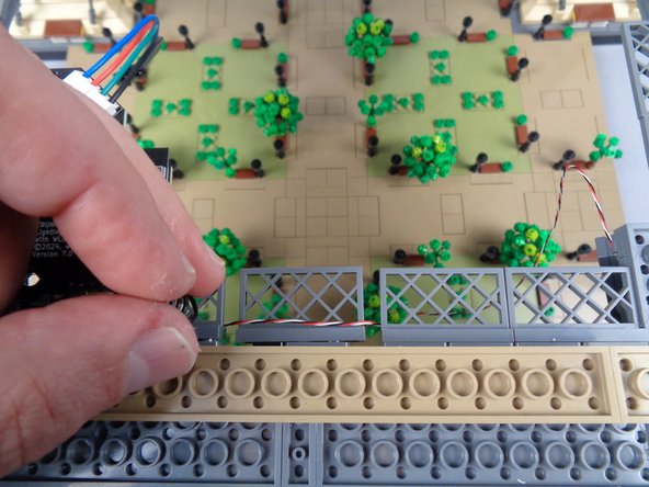 As shown in the photo for this step, you can loop any excess control wire over one of the fence elements to hide it if it hangs down.