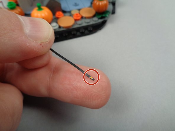 As shown by the red circle in the third photo, the top of the LED light has a very small yellow rectangle.  This is the light itself.