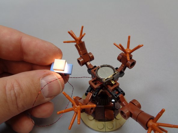 Insert a battery into the holder and the light in your car should turn on as shown in the third photo.