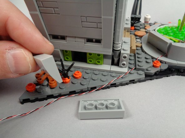 As shown in the second photo for this step, remove two of the side slopes from the base of the town hall.