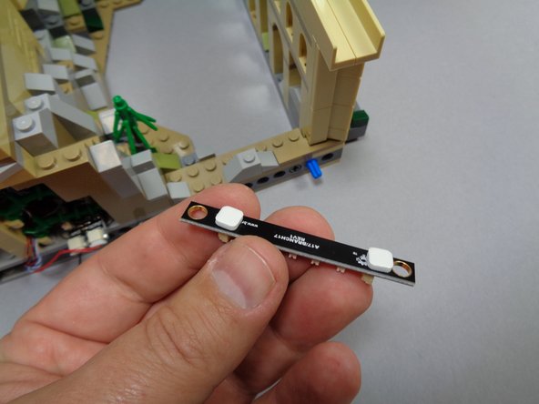 If your kit includes color-changing spotlights, you will now mount the final five of them since your castle is already on its side with the bottom exposed.  If your kit does not include color-changing spotlights, you can skip ahead two steps.