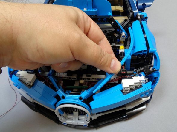 As shown in the first photo, re-attach the blue Technic hose you removed earlier.