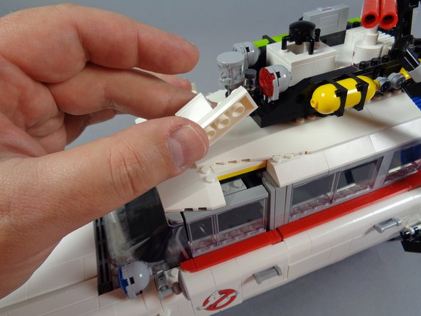 You should now have the roof fully re-assembled, and the two front lightbar mounts should be in place (see the two orange arrows in the third photo).