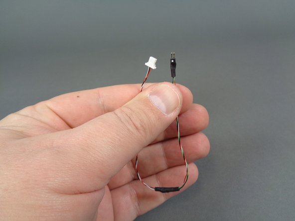 Inside the &quot;Upper Level Lights and Parts&quot; bag, there will be a short cable with two different connectors as shown in the first photo.  One connector is a large 3-wire white plug and the other is a smaller black connector with gold pins and a white dot on one side.