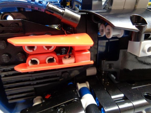 As shown in the two photos for this step, re-assemble the left turn signal assembly.