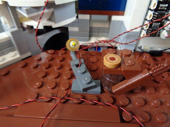 You should still have four spotlights left in the &quot;Warm White Spotlights&quot; bag.  Take these out and mount them along the inner back castle wall so they are approximately evenly spaced.