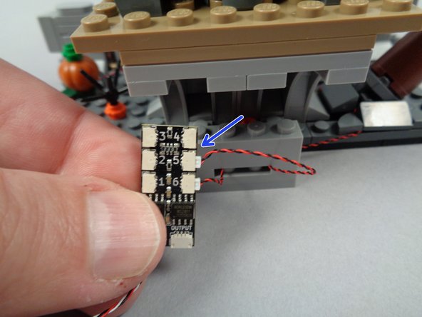 As shown by the arrow in the photo for this step, connect the second green LED light to plug #5 on the BRANCH06X driver board.