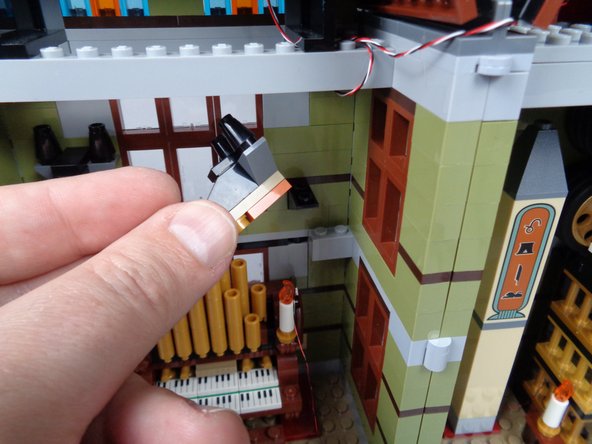 As shown in the first photo for this step, remove the right head assembly from above the organ.