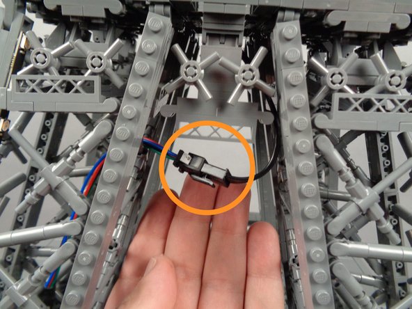 As shown in the second photo, you should now have the male plug (from the top section) and the female plug (from the middle section) accessible and able to reach.