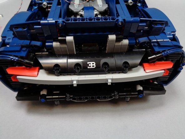 As shown in the three photos for this step, re-assemble the rear right turn signal and tail light mount.