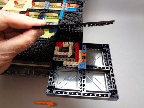 As shown in the first photo for this step, fully remove the large bottom base plate from its foot.