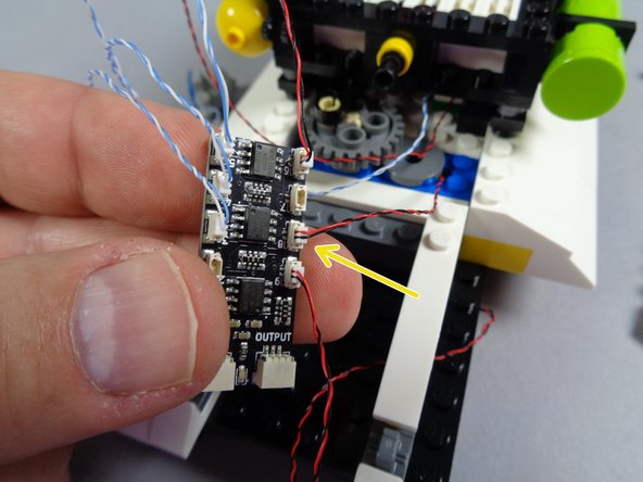 As shown by the orange arrow in the second photo for this step, connect the rear interior light to plug #9 on the BRANCH09X adapter board.