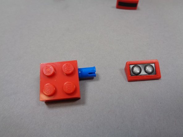 Remove the two top red slopes with the headlight stickers on them.  You won't need these any longer, so you can set them aside or put them back into the LEGO® box your Ferrari set came in.