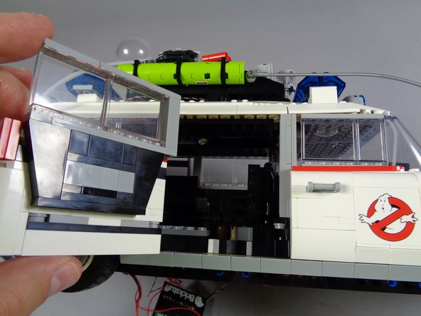 As shown in the first photo for this step, open the side rear door.