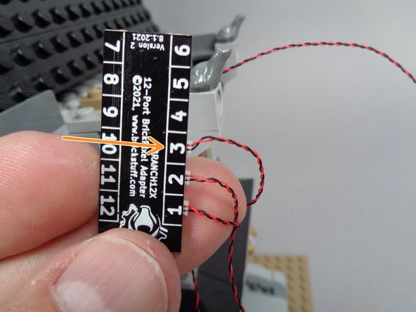 The orange arrow in the third photo shows the back side of the BRANCH12 adapter with the second front porch light connected to plug #3.