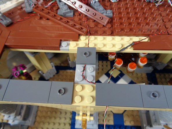 As shown in the second photo, you can remove some of the brown tiles to allow the torch light wires to pass underneath.