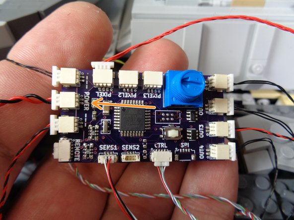 The second power input connects directly to the TRUNK08 master controller via the one remaining open large power connecting plug.  See the second and third photos to identify this plug.