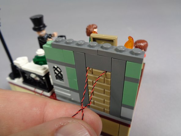 As shown in the first photo, carefully re-attach the top of the main wall section.