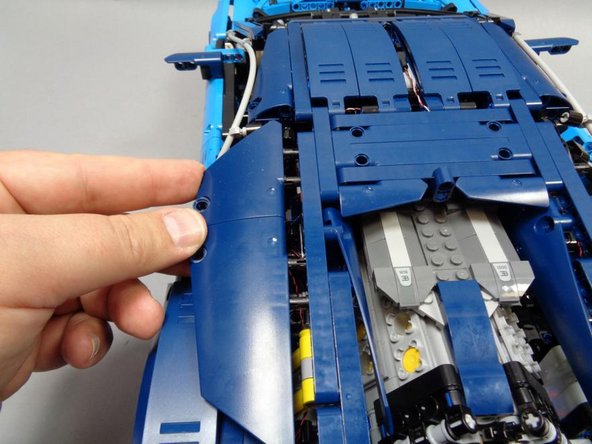 As shown in the second and third photos, close the roof, re-attach the left and right Technic beams, and re-attach the left-side roof panels.