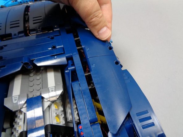 As shown in the first photo, re-attach the right-side Technic panels.