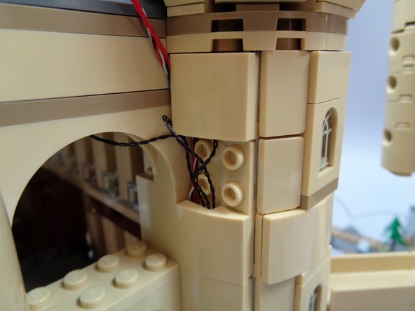 As shown in the first photo, you will have some extra wire hanging out of the castle after connecting the light strips.