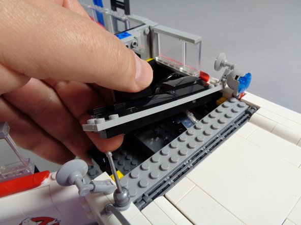 As shown in the first photo for this step, remove the large, transparent windshield part from the Ecto-1 body.