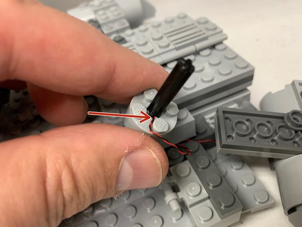 The red arrow in the third photo shows how the smaller engines will have the LED wire wedged next to the black Technic axle once mounted.  These are the most likely to become damaged during installation, so re-insert the Technic axle carefully after mounting the LED.
