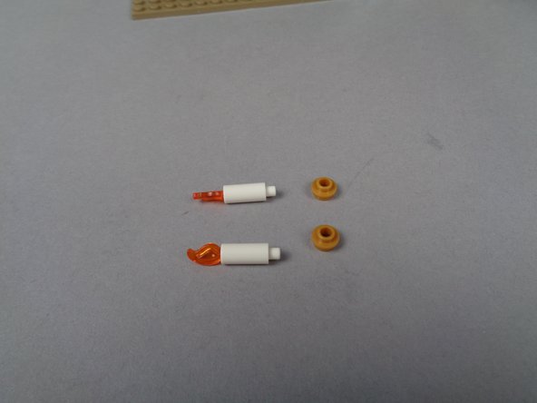 As shown in the photos for this step, remove both candles from the organ, and remove the gold base plate from each candle.