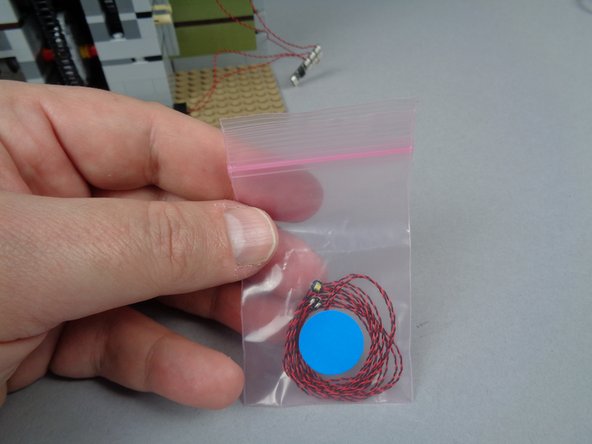 As shown in the first photo for this step, you have a small pink bag inside your BOX #2 with two cool white Pico LED lights inside.