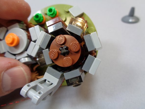 Re-position all pieces around the large hut.  You should now have your mounted light with the wire extending out the back of the hut as shown in the third photo.