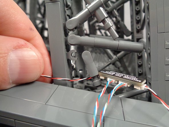 As shown in the second photo, pass the incoming control cable BEHIND the "X" crossbar.