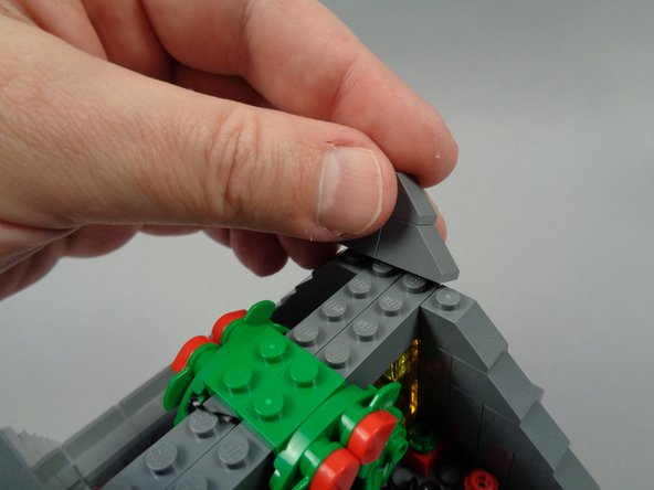 As shown in the photos for this step, re-assemble the rooftop section of Jack's house.