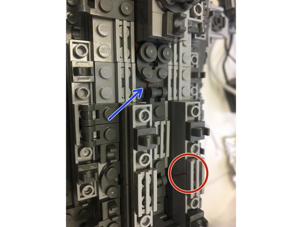 The photos in this step show how the lights should be mounted: lights should be mounted beneath grille tiles (red circles) and wires should run down the sides and between bricks toward the BRANCH15 adapter board (blue arrows).